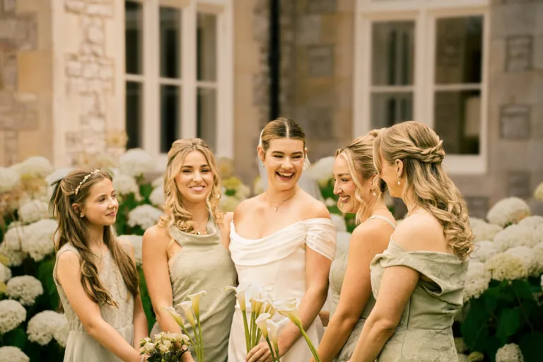 Bride and bridesmaids laughing