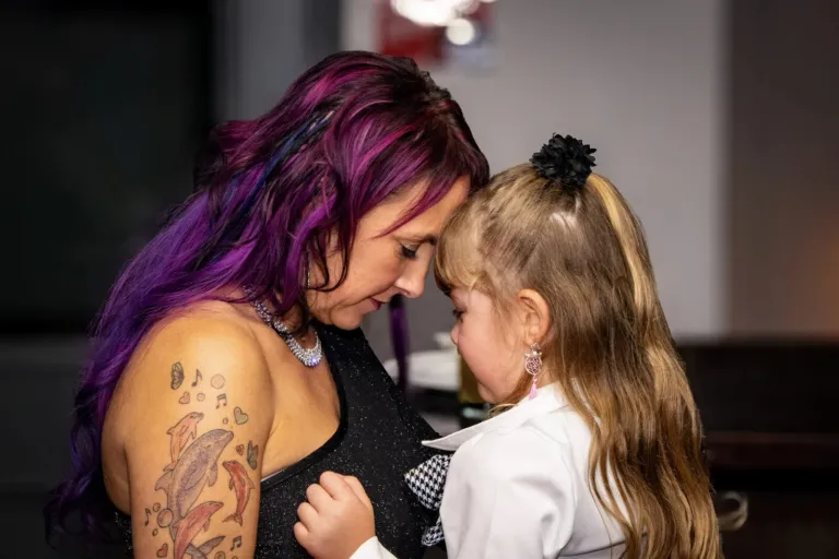 A mum forehead to forehead with a young girl